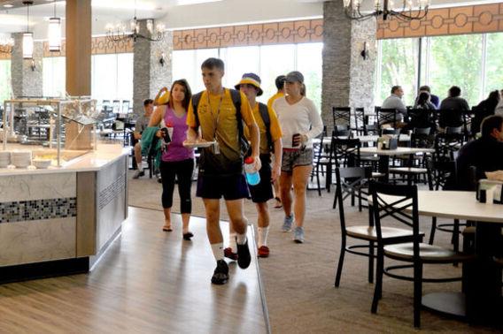 A group of students walk through the dining hall
